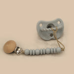 Silicone pacifier and coordinating clip/teether